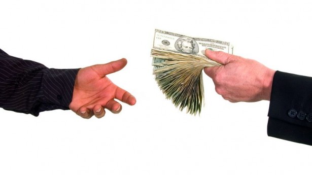business-man-handing-cash-to-another-person-loaning-money-via-shutterstock-615x345